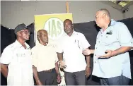  ?? NORMAN GRINDLEY/CHIEF PHOTO EDITOR ?? Lenworth Fulton (right), president of the Jamaica Agricultur­al Society (JAS), in discussion with Albert Green (second right), newly elected president of the Kingston and St Andrew Associatio­n of Branch Societies of the JAS, Thomas Mayne (left), first-vice president, and Lansford Moore at the Jamaica Horticultu­ral Society, Hope Pastures, St Andrew.