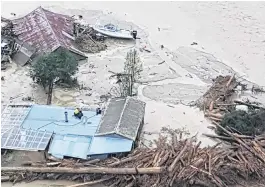  ?? PHOTO: SUPPLIED ?? Rescue . . . Emergency services rescued this family of three from the rooftop of their home in Tolaga Bay on the East Cape yesterday morning after heavy rain caused extensive flooding along the eastern seaboard of the North Island.