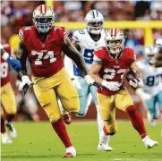  ?? Scott Strazzante/san Francisco Chronicle ?? Spencer Burford, left, leads the way on Christian Mccaffrey’s touchdown in the Super Bowl.