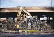  ?? Eric Thayer For The Times ?? CREWS clear debris from the site of an arson fire under the 10 Freeway near downtown Los Angeles.