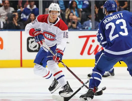  ?? CLAUS ANDERSEN/GETTY IMAGES ?? The Habs’ Jesperi Kotkaniemi flips the puck in against Toronto’s Travis Dermott in an October game: Both teams are part of an unusually crowded playoff race.