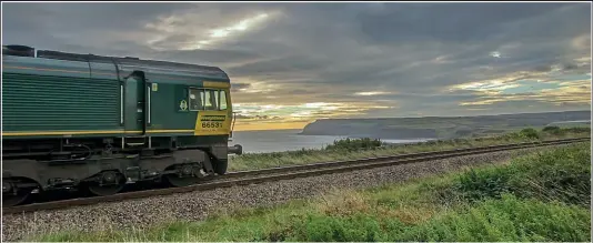  ?? TERRY CALLAGHAN ?? The 07.10 Tees Dock-Boulby Mine, a train of empty potash wagons for reloading, sweeps inland at Hunt Cliff near Saltburn, Cleveland, with 66531 at its head on September 27, 2016.