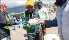  ?? Picture: Courtney Africa/ANA ?? HELPING: SA National Zakah Fund volunteers hand out food to the homeless on the Parade for World Food Day.