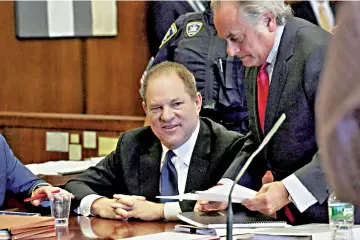  ??  ?? Weinstein speaks to his lawyer Benjamin Brafman inside Manhattan Criminal Court during an arraignmen­t in the Manhattan borough of New York, last July 9. — Reuters file photo