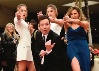  ??  ?? Jimmy Fallon, host of the 74th Annual Golden Globe Awards, poses with Miss Golden Globes 2017 (from left) sisters Sistine, Scarlet and Sophia Stallone after rolling out the red carpet during Golden Globe Awards Preview Day at the Beverly Hilton on Jan...