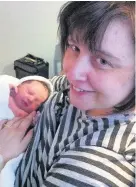  ??  ?? > Kathryn Sheppard, with her newborn daughter Rebecca in 2013