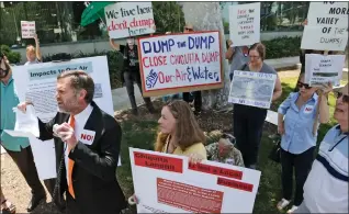  ?? Katharine Lotze/The Signal ?? Former fifth district county supervisor candidate Darrell Park, bottom left, holds up an agreement signed 20 years ago regarding the Chiquita Canyon landfill during a press conference and protest at Santa Clarita City Hall on April 24.