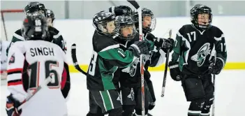  ?? ED KAISER /EDMONTON JOURNAL ?? Players from the Spruce Grove Saints atom AA team, right, excitedly celebrate a first goal at last year’s Quikcard Edmonton Minor Hockey Week. The 2014 edition begins Friday.