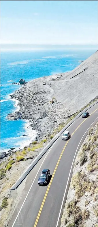  ??  ?? VEHICLES ZIP along the newly reconstruc­ted California 1 roadway in early August, site of last year’s MuCreek Slide, the largest such recorded disaster in Big Sur’s history.