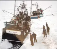  ??  ?? LEFT: A group of sealers passed the time visiting or sitting on their own vessels. Dave Patey says a pathway of stable ice was made for travelling from boat to boat, and often the sealers would get together for a meal or to play cards.