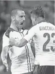  ?? EMMANUEL DUNAND, AFP/ GETTY IMAGES ?? Italy’s Emanuele Giaccherin­i celebrates with Leonardo Bonucci.