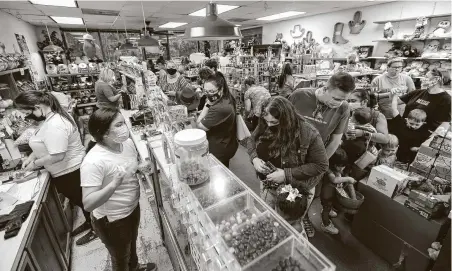  ?? Photos by Jason Fochtman / Staff photograph­er ?? “It is manna from heaven. It was very fulfilling that so many people wanted to help,” Donald Baker said of customers who lined up in droves at The Candy House to help out the business in hard times this past November.