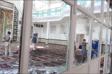  ??  ?? A man cleans debris from the site of a suicide bombing attack in a Shi’ite mosque in Gardez, Paktia province, Afghanista­n. — Reuters photo