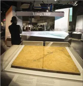  ?? ADRIAN WYLD, THE CANADIAN PRESS ?? A man stands near a wooden relief map used by First World War commanders to plan for the assault on Vimy Ridge, at the Canadian War Museum Wednesday in Ottawa.