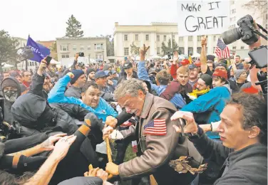  ?? Photos by Leah Millis / The Chronicle ?? Trump backer Tom Condon (center) of San Francisco becomes entangled in a fight at the Berkeley rally.