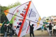  ?? AP PHOTO/AJIT SOLANKI ?? People carry a giant kite made to create awareness about COVID-19 in Ahmedabad, India, on Thursday.