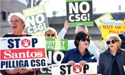  ??  ?? Demonstrat­ors protest against Santos’s plans for a major coal seam gas field near Narrabri. If approved, the project could involve up to 850 coal seam gas wells being drilled on 1,000 hectares of a 95,000 hectare site taking in the Pilliga forest and nearby grazing land. Photograph: Paul Miller/AAP