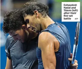  ?? AFP ?? Exhausted: Nadal and Thiem (left) after their five-set battle