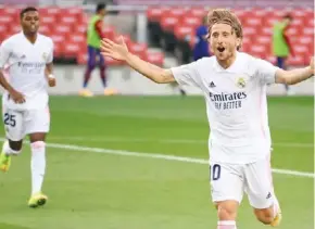  ??  ?? Real Madrid’s Croatian midfielder Luka Modric celebrates after scoring a goal yesterday