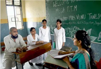  ?? — PTI ?? Parents and teachers interact during the first mega parent- teacher meeting at a government school in East Delhi on Saturday.