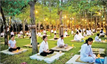  ?? ?? Buddhists meditate at Wat Soriyaram in Battambang province January.