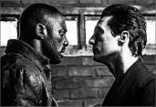  ?? ILZE KITSHOFF/COLUMBIA PICTURES ?? Idris Elba, left, plays Roland, known as the Gunslinger, who protects the tower from a sorcerer called the Man in Black, played by Matthew McConaughe­y.