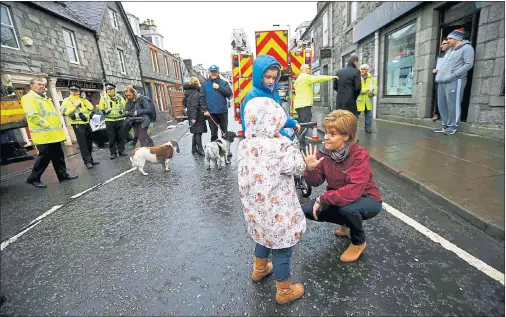  ??  ?? FLOOD RESPONSE: First Minister Nicola Sturgeon meets children during her visit to Newton Stewart, which was badly hit by the heavy rains and gale force winds of Storm Frank.