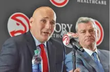  ?? THE ASSOCIATED PRESS ?? New Atlanta Hawks general manager Travis Schlenk, left, speaks as team owner Tony Ressler looks on during an introducto­ry news conference Friday at Philips Arena. Schlenk came from Golden State.