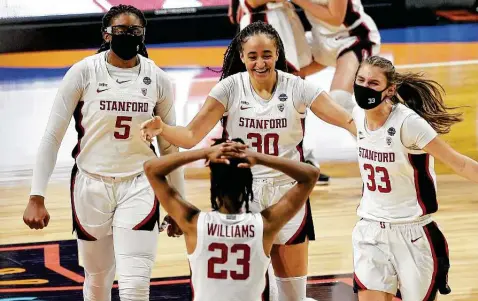  ?? Photos by Kin Man Hui / Staff photograph­er ?? Stanford's Francesca Belibi, left, Haley Jones and Hannah Jump head toward Wagnar grad Kiana Williams to celebrate Stanford's Final Four win.