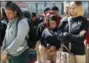  ?? MARTHA IRVINE - THE ASSOCIATED PRESS ?? Peace Warriors from North Lawndale College Prep High School bow their heads during a moment of silence for the victims of gun violence during a Day of Peace rally at Chicago’s Legacy Charter School on Friday, April 20, 2018, which also marked the 19th...