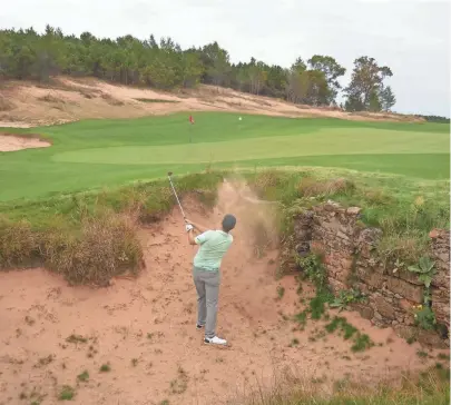  ??  ?? A golfer extricates his ball from a bunker on Mammoth Dunes, which opened May 31.