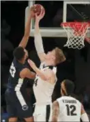  ?? JULIE JACOBSON — THE ASSOCIATED PRESS ?? Purdue’s Isaac Haas (44) blocks a dunk attempt by Penn State’s Josh Reaves (23) during the second half Saturday in New York. Purdue won 78-70.