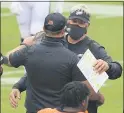  ?? RICH SCHULTZ — THE ASSOCIATED PRESS ?? Eagles coach Doug Pederson, right, hugs Cincinnati Bengals counterpar­t Zac Taylor after the teams battled to a 23- 23tie at Lincoln Financial Field Sunday.