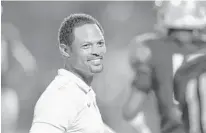  ?? MICHAEL LAUGHLIN/SUN SENTINEL ?? St. Thomas coach Roger Harriott cracks a rare smile during the second half of their 7A regional final game against Dwyer, Nov. 23.