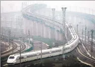  ?? STR / AFP/Getty Images ?? A train which can run at speeds up to 185 miles per hour goes on a trial run in Shanghai on May 11, 2011.