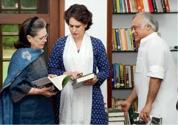  ?? — PTI ?? Congress president Sonia Gandhi and Priyanka Gandhi Vadra at the release of the book Indira Gandhi: A Life in Nature, written by former Union Minister Jairam Ramesh (right), at Indira Gandhi Memorial Museum in New Delhi on Saturday evening.