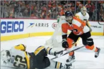  ?? TOM MIHALEK — THE ASSOCIATED PRESS ?? The Flyers’ Claude Giroux, right, levels the Penguins’ Carl Hagelin during the second period Sunday in Philadelph­ia.