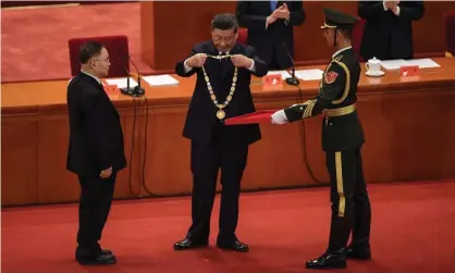  ??  ?? Zhang Boli (left), an expert in traditiona­l Chinese medicine, receives an award from Xi Jinping at the Great Hall of the People in Beijing on Tuesday. Photograph: Nicolas Asfouri/AFP/Getty Images