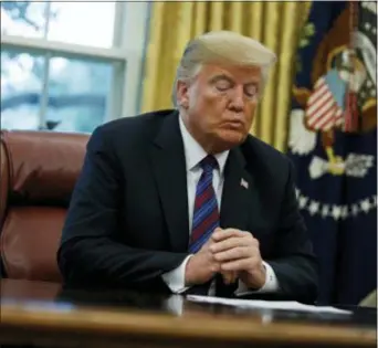  ?? EVAN VUCCI — THE ASSOCIATED PRESS ?? President Donald Trump talks on the phone with Mexican President Enrique Pena Nieto, in the Oval Office of the White House, Monday in Washington. Trump is announcing a trade “understand­ing” with Mexico that could lead to an overhaul of the North American Free Trade Agreement.
