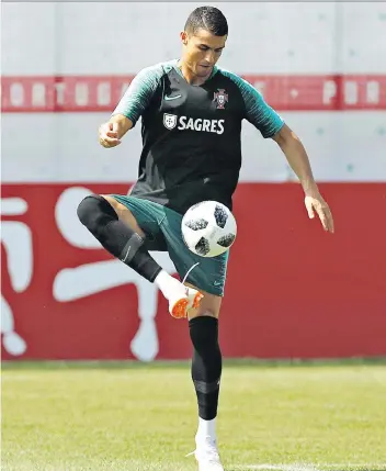  ?? THE ASSOCIATED PRESS ?? Like Argentina’s Lionel Messi, Portugal’s Cristiano Ronaldo, shown in practice Sunday, has a mediocre squad to work with at the World Cup, but he’s hell bent to push them through the group stage.