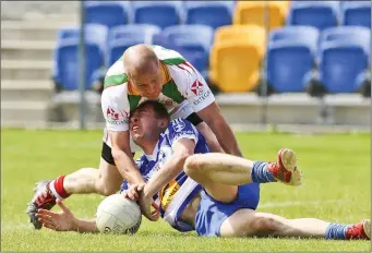  ??  ?? Kiltegan’s Jeffrey Bermingham swarms all over Blessingto­n’s Patrick O’Connor.