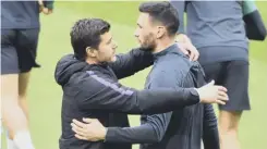  ??  ?? 0 Mauricio Pochettino and keeper Hugo Lloris share an intimate moment during a training session in Amsterdam yesterday.