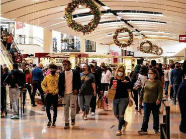  ?? Photos by Matthew Busch / Contributo­r ?? Holiday shoppers make their way through North Star Mall this month. One U.S. retail group forecasts that sales will rise between 3.6 and 5.2 percent in November and December, compared with the same period in 2019.