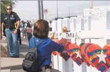  ?? Getty Images ?? Members of the “Crosses for Losses’' group arrive at the scene with crosses for each victim, after the shooting that left 21 people dead at the Cielo Vista Mall WalMart in El Paso, Texas, over the weekend.