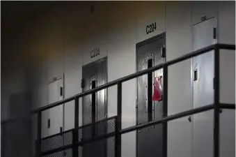  ?? (Aaron Lavinsky/Star Tribune via AP, File) ?? FILE - In this Monday, Jan. 4, 2021, file photo, a red tag hangs on a cell door, signifying an active COVID-19 case for its inhabitant­s at Faribault Prison, in Faribault, Minn. A Tennessee advisory panel tasked with determinin­g eligibilit­y for the COVID-19 vaccine acknowledg­ed that prison inmates in the state were high risk, but concluded that prioritizi­ng them for inoculatio­n could be a “public relations nightmare.”