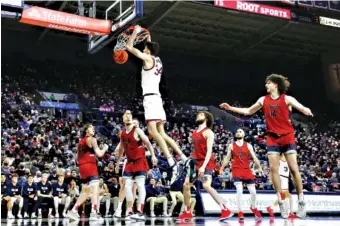  ?? AP PHOTO/YOUNG KWAK ?? Gonzaga center Chet Holmgren (34) dunks during the second half of the Bulldogs’ victory over Saint Mary’s on Saturday in Spokane, Wash.