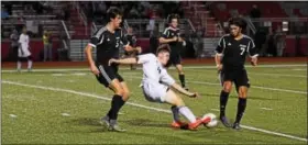  ??  ?? Pottsgrove’s Pat O’Brien, center, tries to play the ball up field amid pressure from Boyertown’s Nik Verma, right, and Sam Marks.