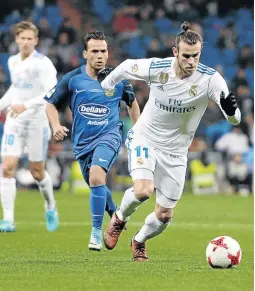  ?? / SONIA CANADA / GETTY IMAGES ?? Gareth Bale came off the bench to help tee up a double for Borja as Real drew 2-2.