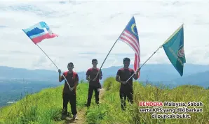  ??  ?? BENDERA Malaysia, Sabah serta KRS yang dikibarkan di puncak bukit.