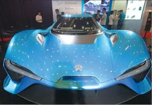  ?? FAN JIASHAN / FOR CHINA DAILY ?? Visitors check out a NIO EP9 electric vehicles stand on display at an auto show in Beijing.